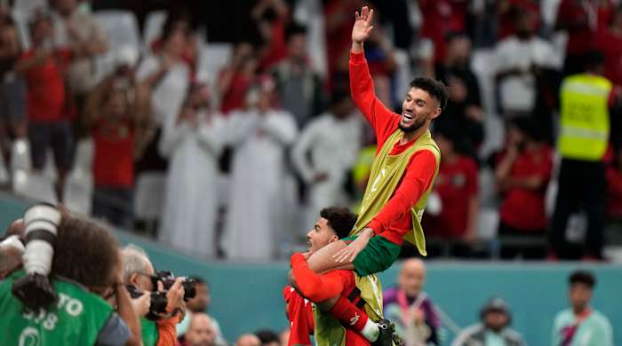 Noussair Mazraoui being lifted in the air after a win.